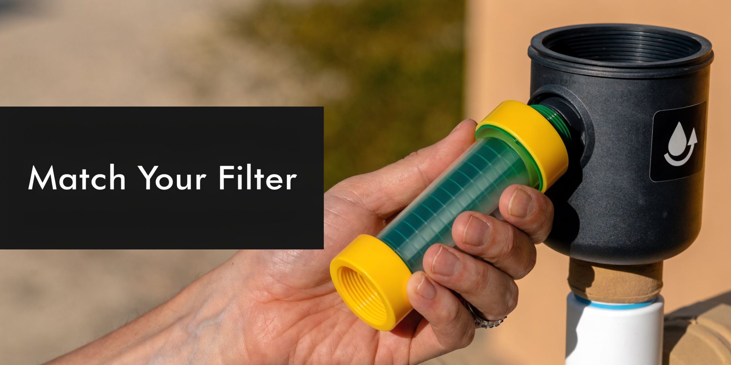 A person holding a cylindrical green water filter cartridge with yellow caps, ready to install it.