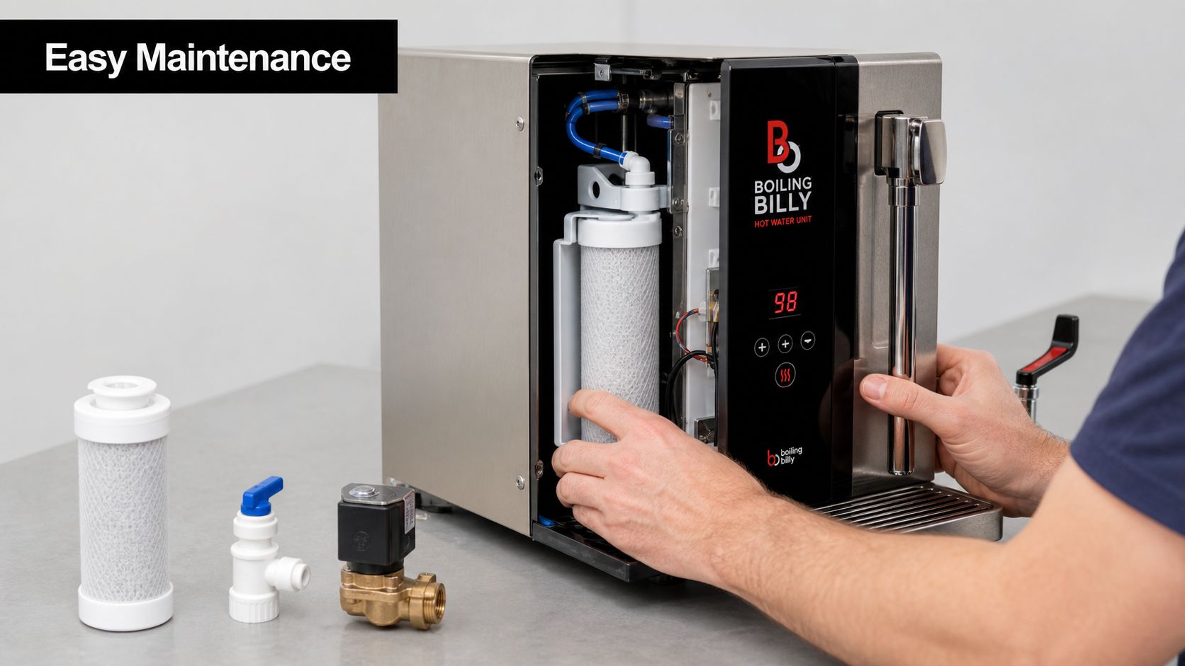 A technician performing routine maintenance on a Boiling Billy hot water unit by replacing the water filter.