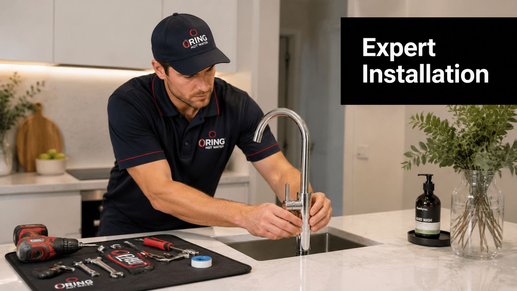 A professional plumber installing a modern kitchen tap while tools are laid out on a work mat.